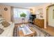 Inviting living room featuring natural light, hardwood floors, and comfortable seating arrangement at 3054 Bright Dr, Holiday, FL 34691