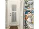 Organized pantry with shelving and door to the outside ensures efficient kitchen storage at 3054 Bright Dr, Holiday, FL 34691