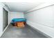 Carpeted sunroom with a hot tub covered with a blue tarp and hurricane shutters at 3054 Bright Dr, Holiday, FL 34691