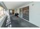 View of the carpeted sunroom featuring bright natural light and access to the backyard at 3054 Bright Dr, Holiday, FL 34691