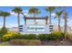 Evergreen community sign with lush landscaping, stone accents, and decorative pergola detail at 3832 Turning Tides Ter, Bradenton, FL 34208