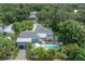 Aerial view of the property showcasing pool, patio, and lush tropical landscaping at 5114 N Branch Ave, Tampa, FL 33603