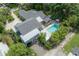 Drone's eye view showcasing the backyard pool, outdoor kitchen, and covered parking at 5114 N Branch Ave, Tampa, FL 33603