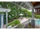 Charming backyard patio area with a stone fountain, outdoor seating under a pergola, surrounded by lush greenery at 5114 N Branch Ave, Tampa, FL 33603