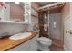 Charming bathroom featuring a glass door shower and a wood countertop with a white sink at 5114 N Branch Ave, Tampa, FL 33603