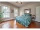 Serene bedroom featuring hardwood floors, large windows with bright natural light, and a comfortable bed at 5114 N Branch Ave, Tampa, FL 33603