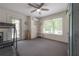 Bright bonus room featuring neutral decor, a ceiling fan, a large window, and a glass paneled exterior door at 5114 N Branch Ave, Tampa, FL 33603