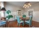 Charming dining room featuring hardwood floors, wainscoting, and a unique chandelier at 5114 N Branch Ave, Tampa, FL 33603