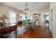 Dining room featuring hardwood floors, bright natural light, and a round table with chairs at 5114 N Branch Ave, Tampa, FL 33603
