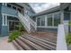 Elegant exterior with wooden deck, white railings, and stairs, enhancing the home's curb appeal at 5114 N Branch Ave, Tampa, FL 33603