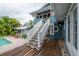 Picturesque exterior featuring a pool and a staircase leading to an upper-level deck at 5114 N Branch Ave, Tampa, FL 33603