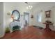 Inviting foyer featuring hardwood floors, a nautical-themed mirror and decor, and a decorative glass front door at 5114 N Branch Ave, Tampa, FL 33603