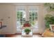 French doors with views of the yard and a decorative table with plants and shells at 5114 N Branch Ave, Tampa, FL 33603