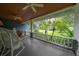 Inviting covered front porch with rocking chair and a view of the landscaped front yard at 5114 N Branch Ave, Tampa, FL 33603