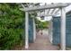 Tranquil garden entrance with arbor and gate, creating a welcoming pathway to the outdoor space at 5114 N Branch Ave, Tampa, FL 33603