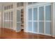 Hallway featuring hardwood floors and multiple storage closets at 5114 N Branch Ave, Tampa, FL 33603
