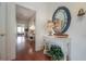 Hallway with wood floors, a decorated table, and a large mirror with nautical decor accents at 5114 N Branch Ave, Tampa, FL 33603