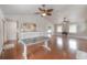 Open-concept living area with hardwood floors, high ceilings, and a stylish table, perfect for entertaining at 5114 N Branch Ave, Tampa, FL 33603