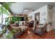 Inviting living room featuring comfortable seating, a ceiling fan, and large windows at 5114 N Branch Ave, Tampa, FL 33603