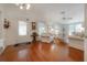 Bright living room featuring hardwood floors, comfortable seating, and a front door with leaded glass at 5114 N Branch Ave, Tampa, FL 33603