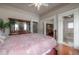 Main bedroom featuring hardwood floors, with a glimpse into the en-suite bathroom at 5114 N Branch Ave, Tampa, FL 33603