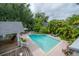 Resort-style pool with brick pavers and beautiful tropical landscaping, perfect for relaxation and recreation at 5114 N Branch Ave, Tampa, FL 33603