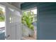 Charming doorway on the porch leading to lush tropical landscaping and garden views at 5114 N Branch Ave, Tampa, FL 33603