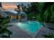 Beautiful backyard pool with brick pavers and lush tropical landscaping at 5114 N Branch Ave, Tampa, FL 33603