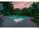 Tranquil swimming pool area with brick pavers and lush tropical landscaping at 5114 N Branch Ave, Tampa, FL 33603