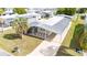 Aerial view of single-story home featuring carport, palm tree and neat landscaping at 5238 Vera St, Zephyrhills, FL 33542
