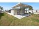 Charming home featuring a covered patio and a well-maintained lawn, perfect for outdoor gatherings at 5238 Vera St, Zephyrhills, FL 33542