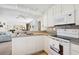 Functional kitchen with white cabinetry, modern appliances, and an efficient layout at 5238 Vera St, Zephyrhills, FL 33542