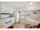 Bright kitchen with all-white appliances and a dining table near the window at 5238 Vera St, Zephyrhills, FL 33542