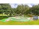 Aerial view of the miniature golf course featuring green turf, a gazebo, and shade trees at 5238 Vera St, Zephyrhills, FL 33542