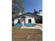 Charming home featuring a unique blue and white exterior, covered carport, and fenced front yard at 5511 N 32Nd St, Tampa, FL 33610