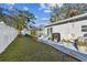 Manicured backyard with a lush lawn, flower beds, and a walkway leading to a screened patio at 5631 3Rd N Ave, St Petersburg, FL 33710