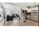 Open-concept living room and kitchen with tiled floors, recessed lighting, ceiling fan, and natural light at 5631 3Rd N Ave, St Petersburg, FL 33710