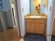 Hall bathroom with a wood vanity, mirror, and doorway views to other rooms at 586 Rodeo Dr, Largo, FL 33771