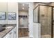 Bathroom showcasing a glass-enclosed shower, granite counters, and open access to walk-in closet at 6206 Timberdale Ave, Wesley Chapel, FL 33545
