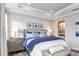 Tastefully appointed bedroom with king bed, side tables, and a view of the ensuite bathroom at 6206 Timberdale Ave, Wesley Chapel, FL 33545