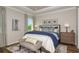 Comfortable bedroom with tray ceiling, bench seat, and framed art above a padded headboard at 6206 Timberdale Ave, Wesley Chapel, FL 33545