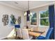 Dining room with a modern chandelier, a wooden table and seating for six at 6206 Timberdale Ave, Wesley Chapel, FL 33545