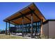 Modern architectural design with wood and metal accents, large windows, and comfortable outdoor seating at 6206 Timberdale Ave, Wesley Chapel, FL 33545