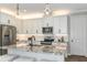 Bright kitchen features stainless steel appliances, white cabinetry, and a granite countertop island at 6206 Timberdale Ave, Wesley Chapel, FL 33545