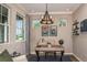 Stylish home office with a rustic desk, comfortable seating, and ample natural light at 6206 Timberdale Ave, Wesley Chapel, FL 33545