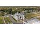 Aerial view showcasing modern townhomes with rooftop patios in a green and spacious neighborhood at 6207 64Th N Way, Pinellas Park, FL 33781