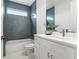 Stylish bathroom with blue tile, tub, vanity with modern faucet and fixtures, and window for natural light at 6207 64Th N Way, Pinellas Park, FL 33781