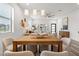 Bright dining area with modern light fixtures, wood table, and comfortable seating at 6207 64Th N Way, Pinellas Park, FL 33781