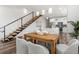 Open dining area with seating for four, next to an open staircase and a modern kitchen at 6207 64Th N Way, Pinellas Park, FL 33781