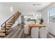 Open-concept dining area with modern light fixtures, stairs and gray wood flooring at 6207 64Th N Way, Pinellas Park, FL 33781